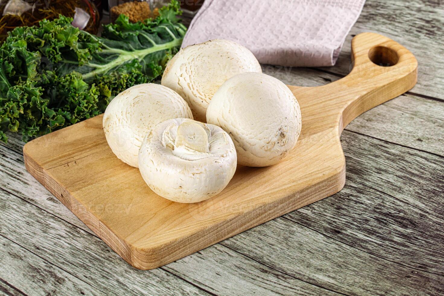 A wooden cutting board with mushrooms on it photo