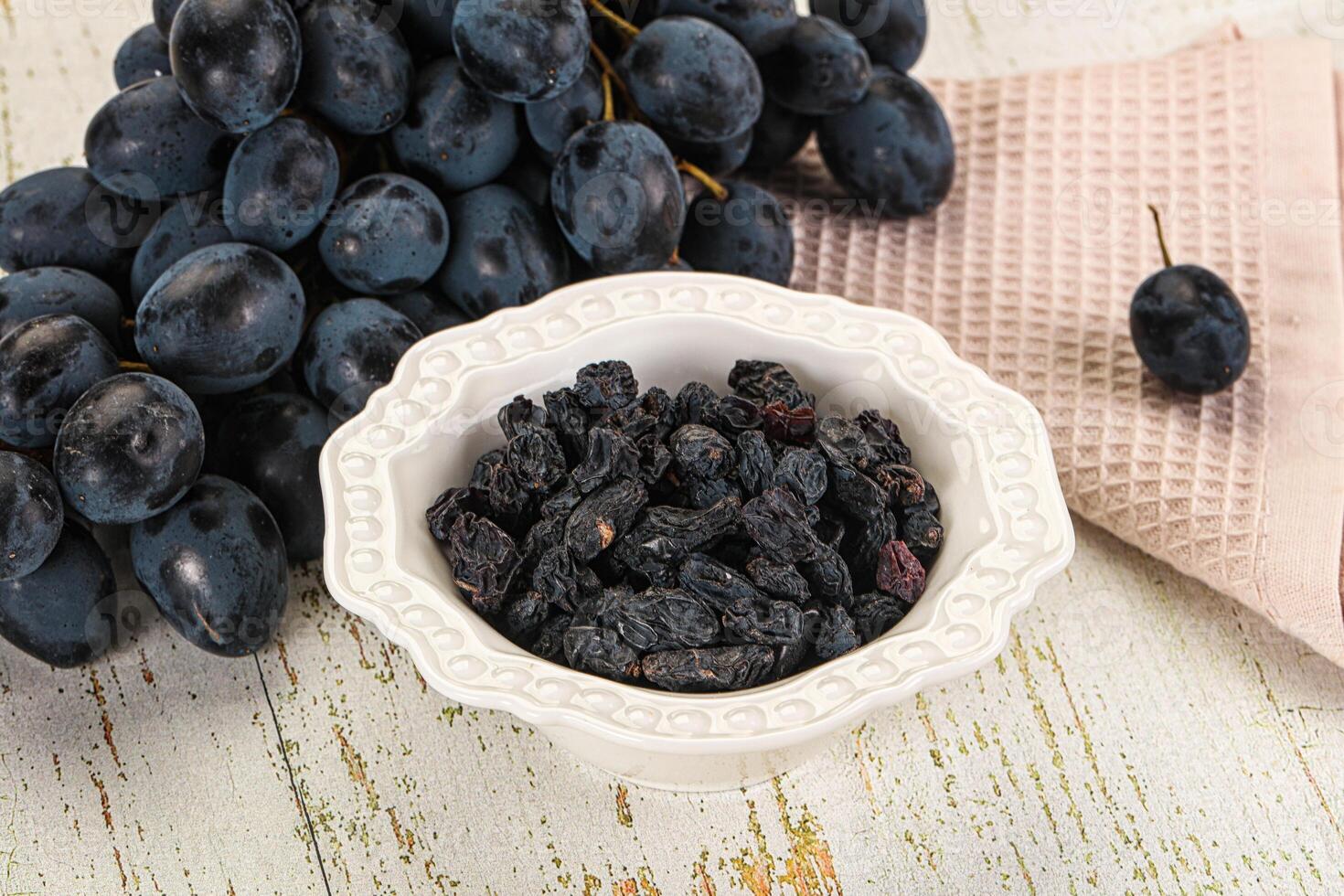 A bowl of black grapes photo