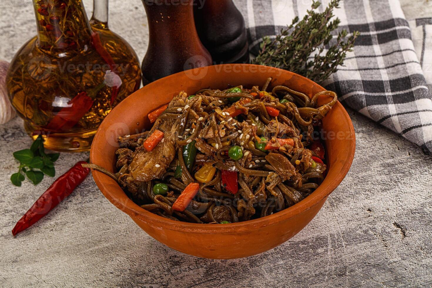 A bowl of noodles with vegetables and garlic photo