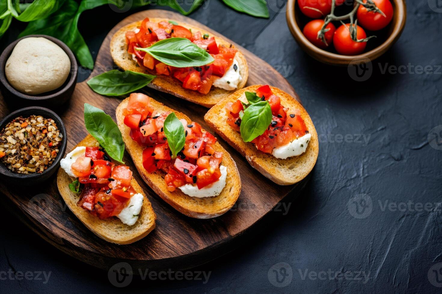 Delicious bruschetta with tomatoes, cream cheese and basil resting on wooden board photo