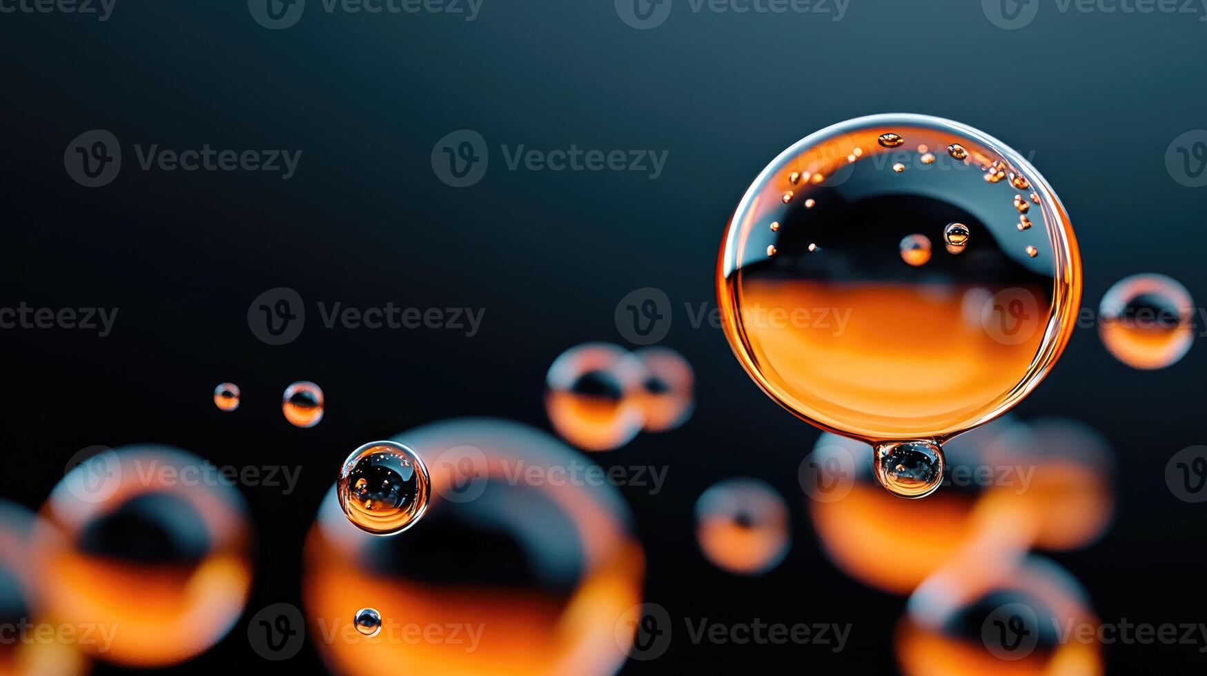 Orange liquid spheres hanging with small bubbles inside on a dark background photo