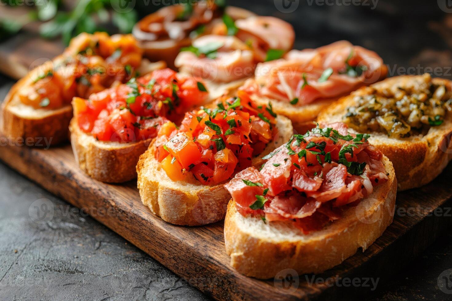 Delicious bruschetta with tomatoes, ham, and pesto resting on wooden board photo
