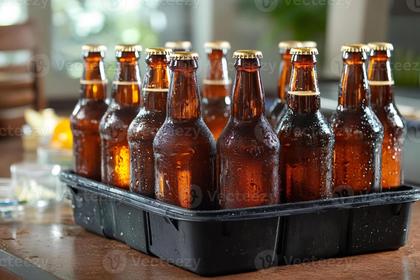Cold beer bottles resting in black plastic crate on table photo