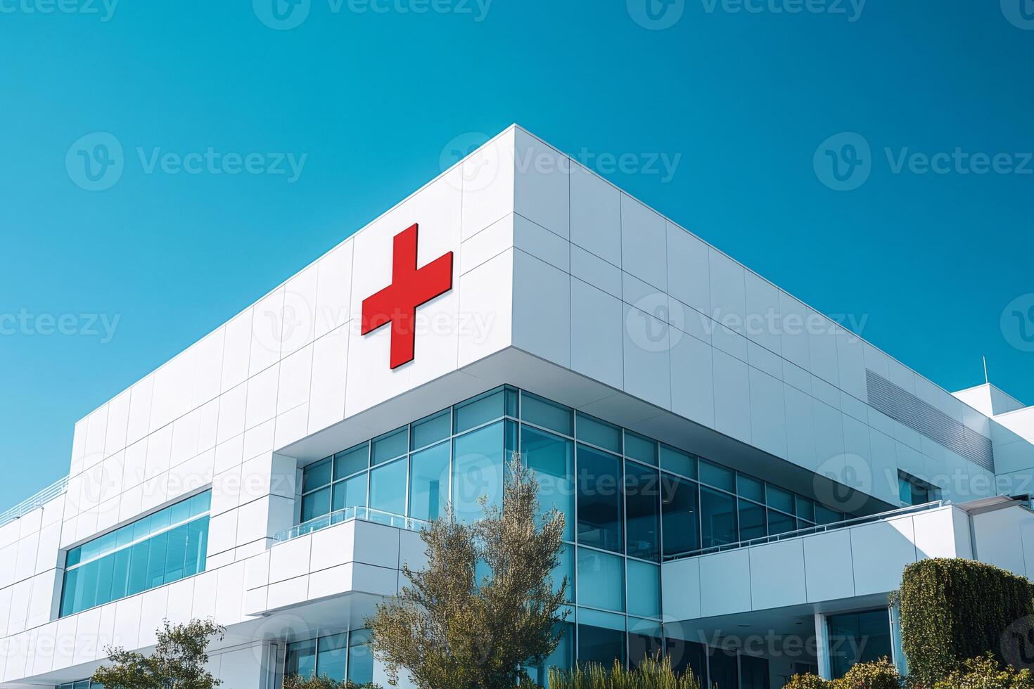 Modern hospital building with red cross symbol on facade displaying healthcare services photo