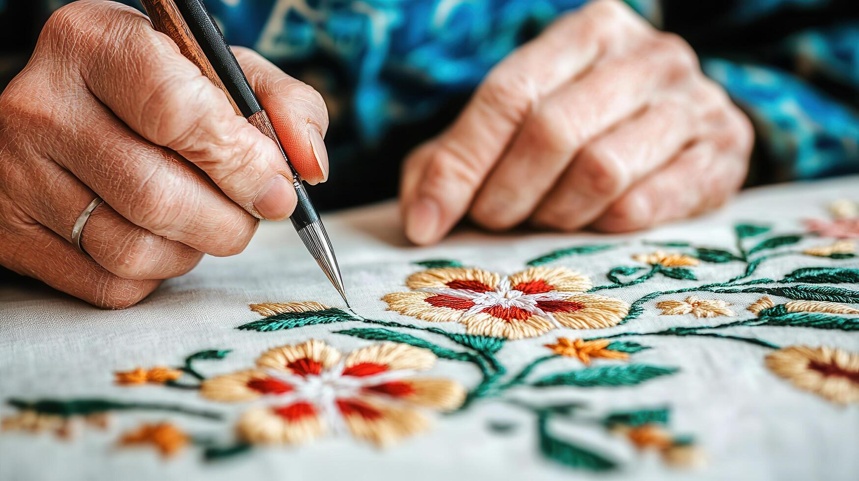 Close up of Elderly Hands Skillfully Embroidering Delicate Floral Design on White Fabric photo