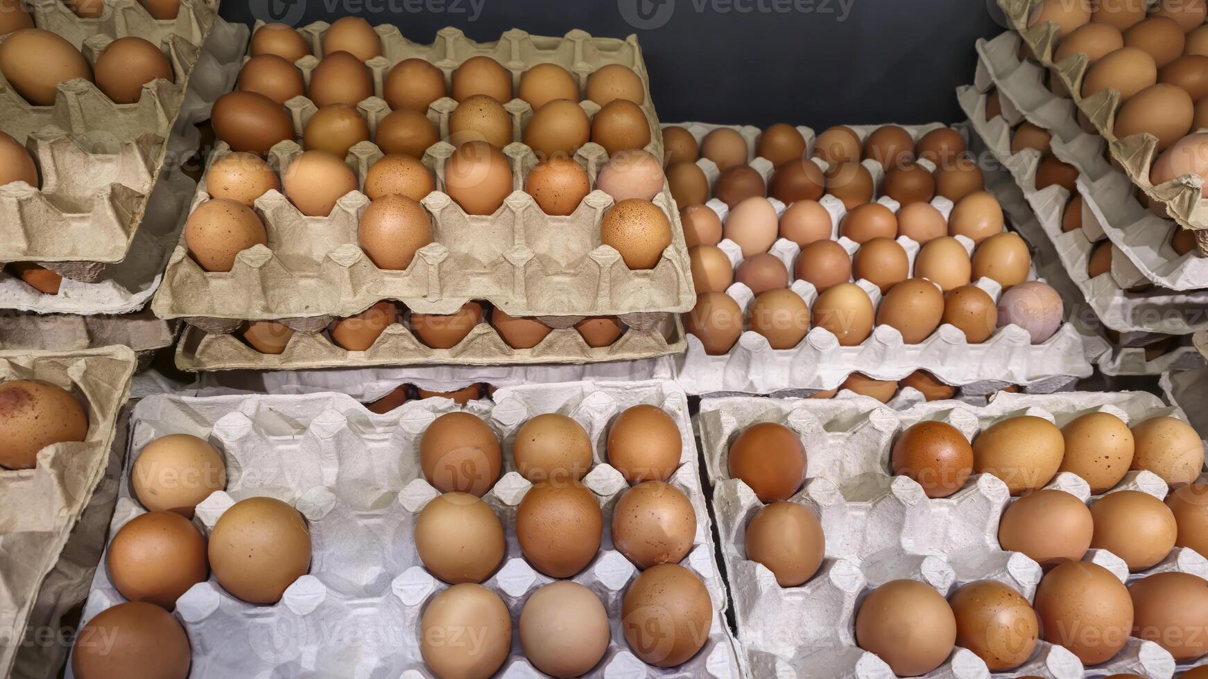Chicken eggs lie in trays on display in a store Grocery shopping. photo