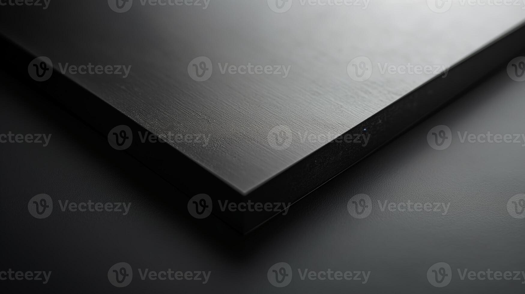 Close-up of a sleek, black surface with subtle texture and reflections, creating a modern and minimalistic aesthetic. photo