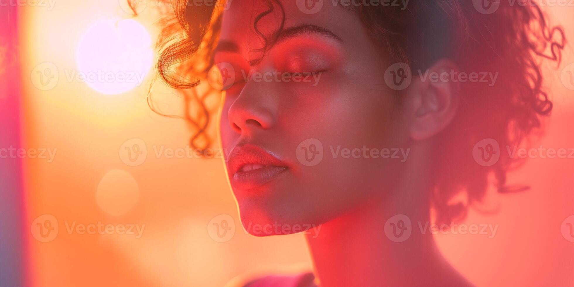 A serene young woman with curly hair, lost in thought against a vibrant, colorful backdrop. Her peaceful expression radiates calm. photo