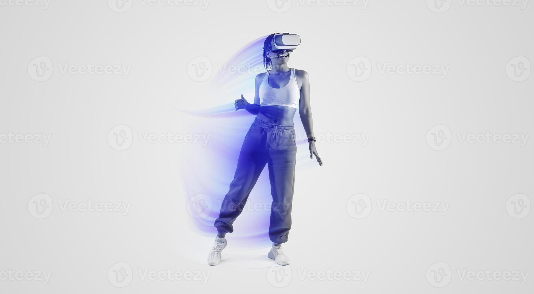 Happy African American woman dancing in virtual reality headset, enjoying her virtual reality experience while exploring 3D technology over pink neon light background, full length photo