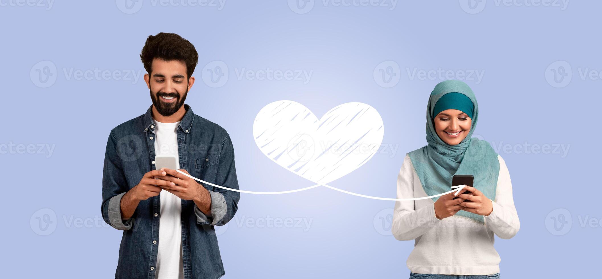 A couple expresses their love for each other on Valentine's Day. They use their smartphones to send affectionate messages while smiling, creating a connection through technology. photo