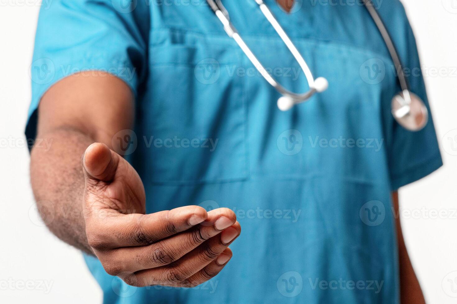 African American man doctor extends his hand, inviting patients into his care at a hospital, cropped. He wears scrubs, symbolizing professionalism in healthcare. photo