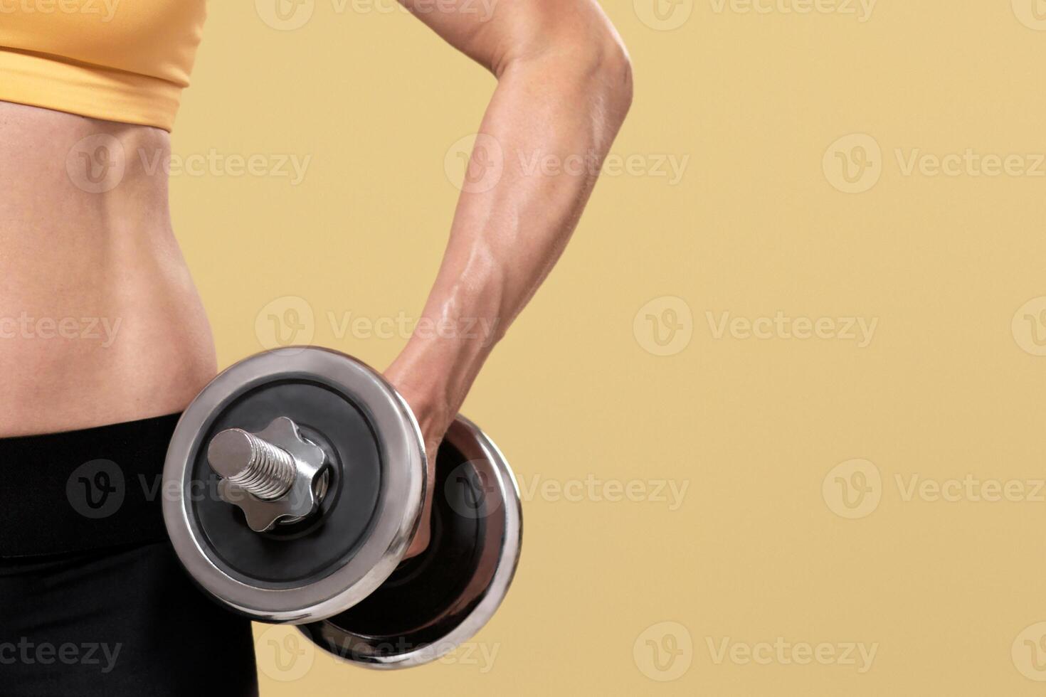 Lifting, strength training, sports lifestyle. Muscular middle aged female in sportswear raises dumbbell, isolated on beige background, studio shot, cropped, panorama, free space, studio shot photo