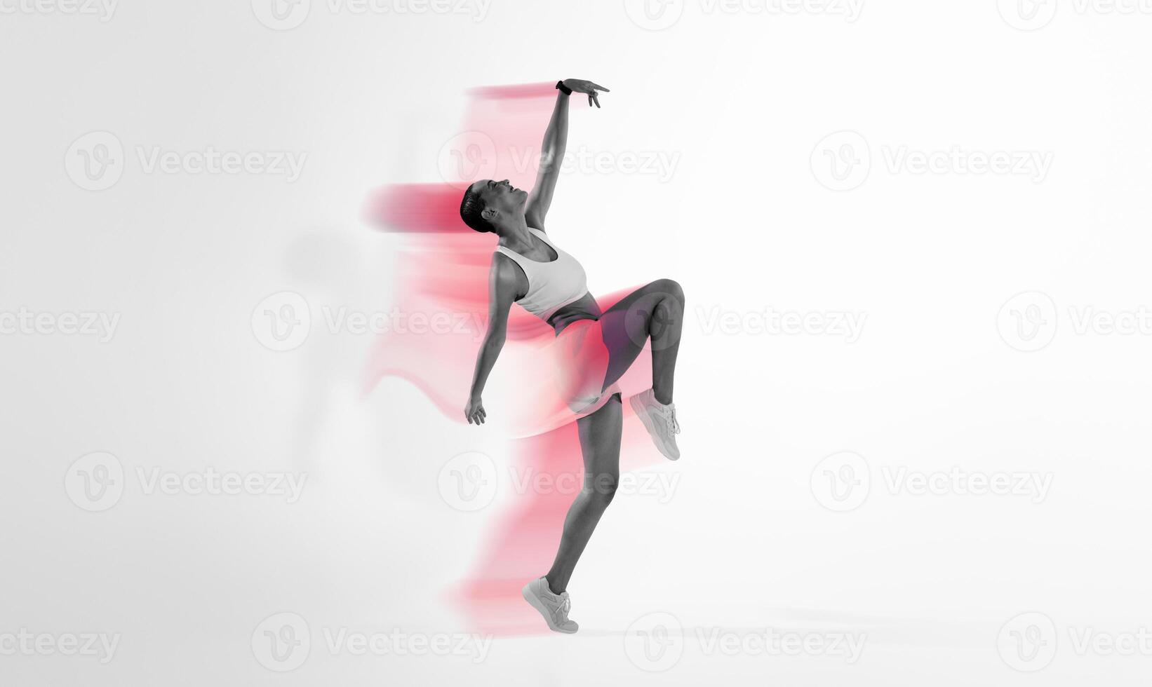 An exuberant latin young dancer in a dynamic pose captures the essence of movement and grace, set against a gradient pink and yellow background. Sport, fitness and weight loss photo