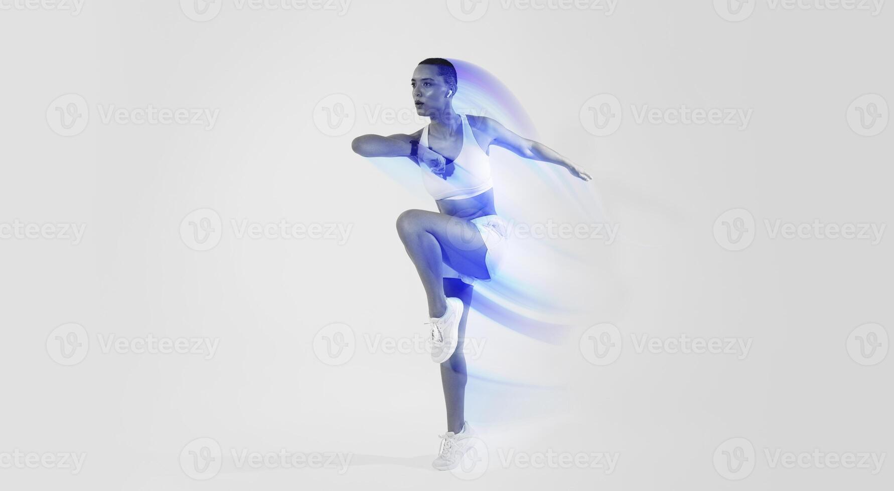 Focused millennial latin woman in sportswear, wireless headphones run, jump, make active workout, listen music on neon pink studio background. Body care, cardio sport, full length photo
