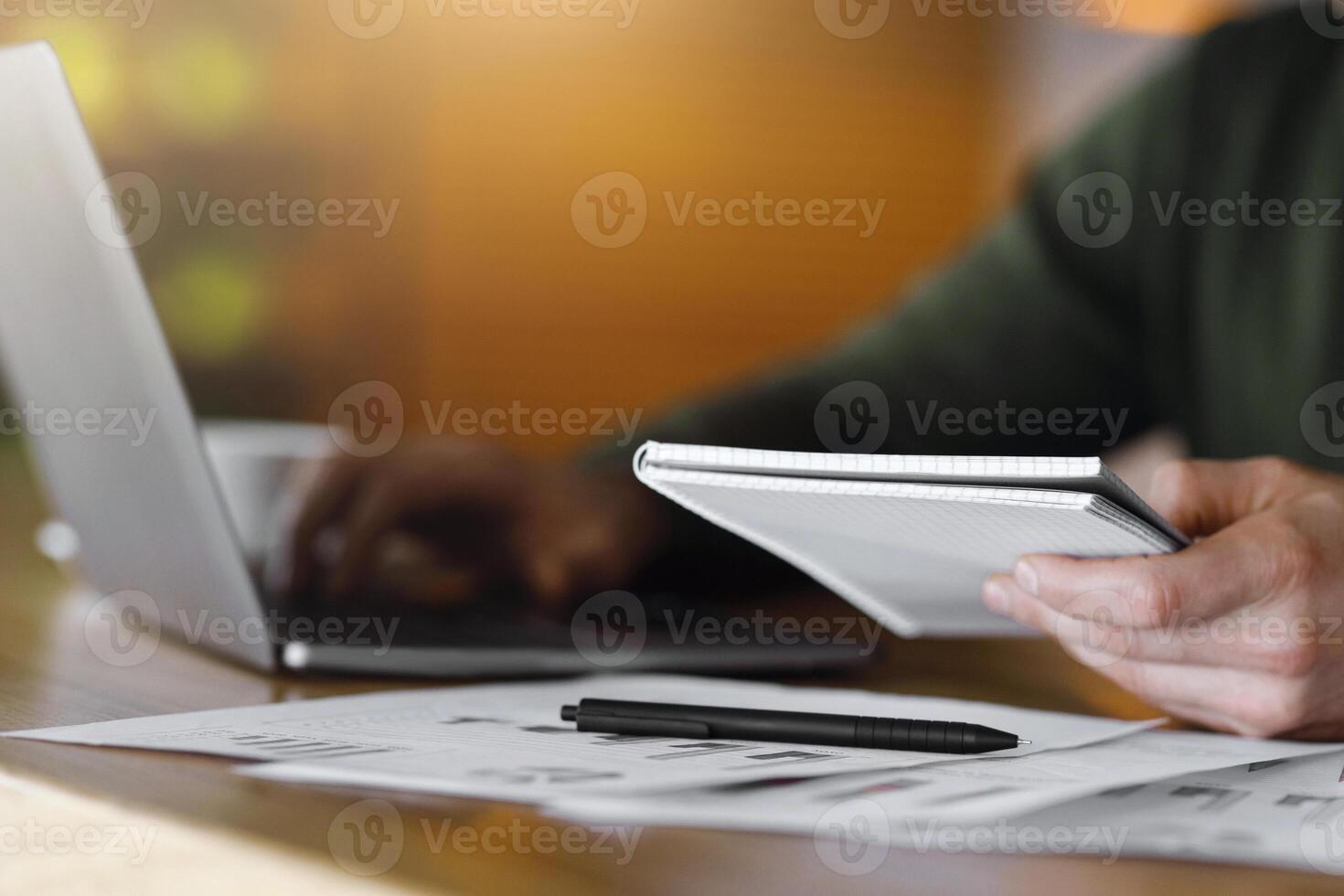 Cropped of blogger creating new article, working online at cafe, using laptop photo