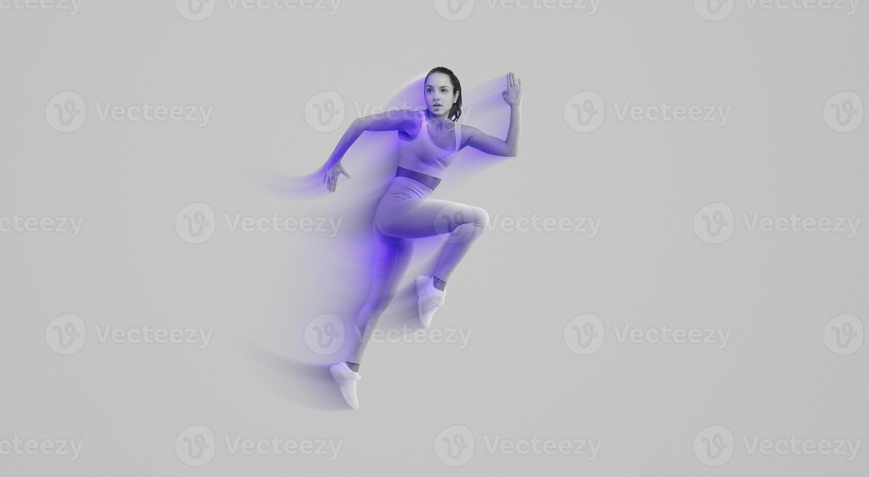 A woman wearing a pink outfit is captured mid-air as she jumps energetically. Her arms are outstretched and her legs are bent, showcasing a moment of dynamic movement and joy. photo