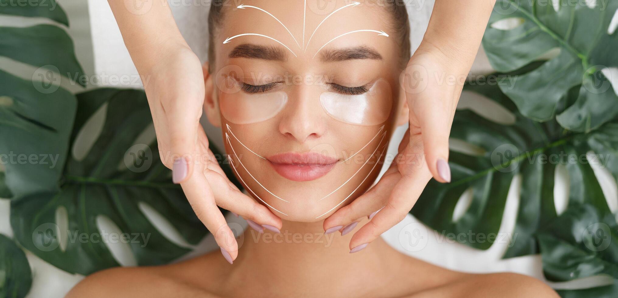 A woman relaxes during a facial massage, receiving pampering to enhance her skin. The treatment includes anti-aging techniques in a tranquil and natural setting. photo