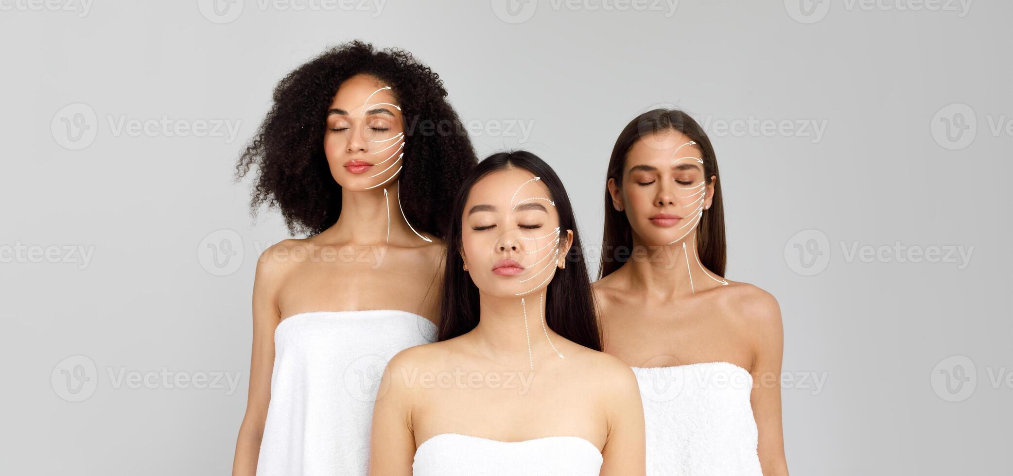 Three multiethnic women are undergoing a relaxing facial massage, showcasing various skin care techniques for rejuvenation. The atmosphere is serene and focused on pampering and anti-aging benefits. photo