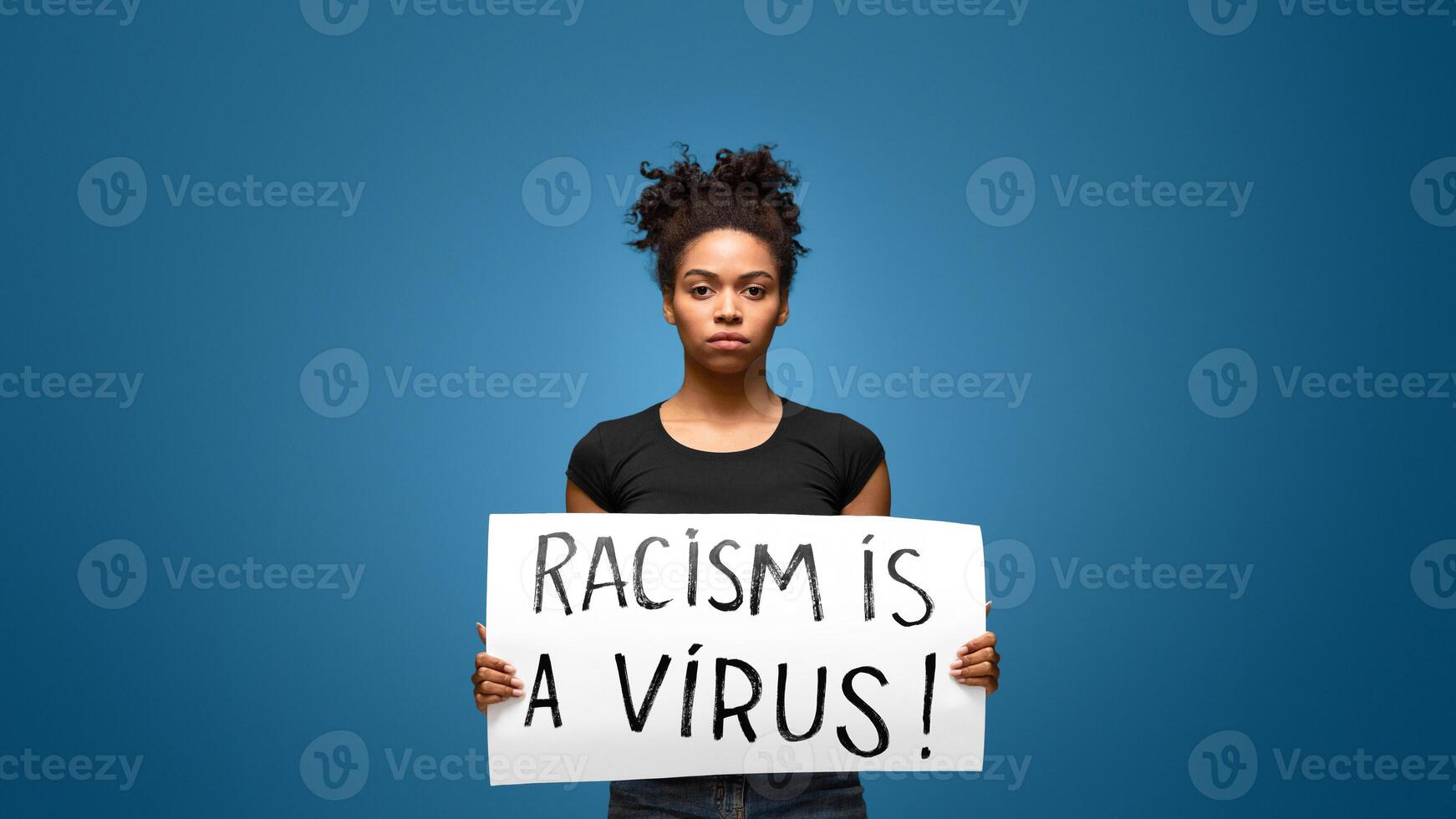 Racism is a Virus. Black girl holding banner for protest, rally or awareness campaign against racial discrimination of dark skin color. photo