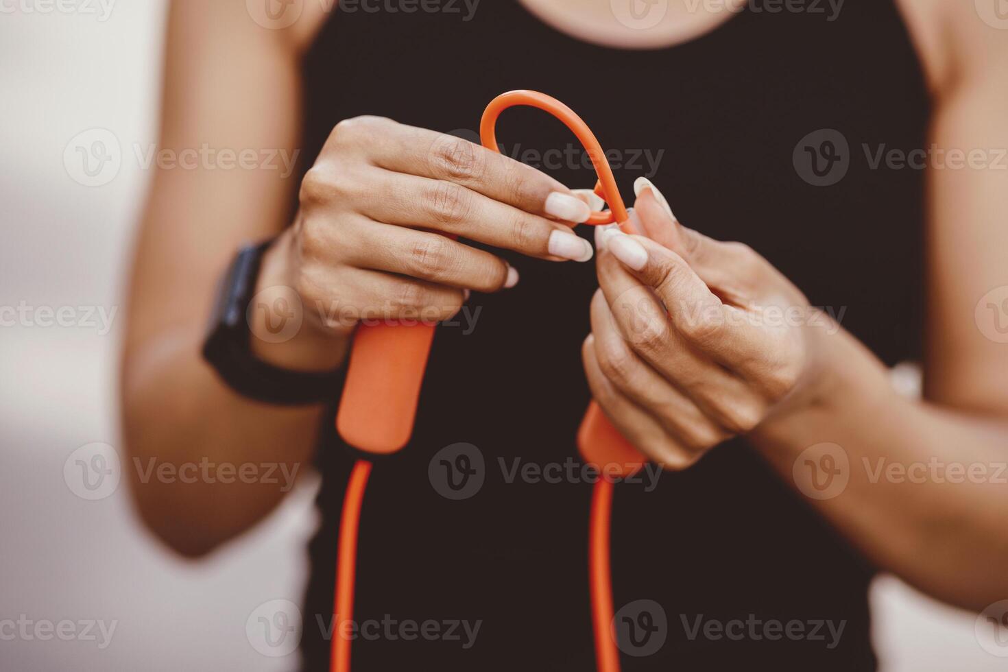 Preparation for training. African american girl with fitness tracker, knotted rope on knot, cropped, close up, free space photo