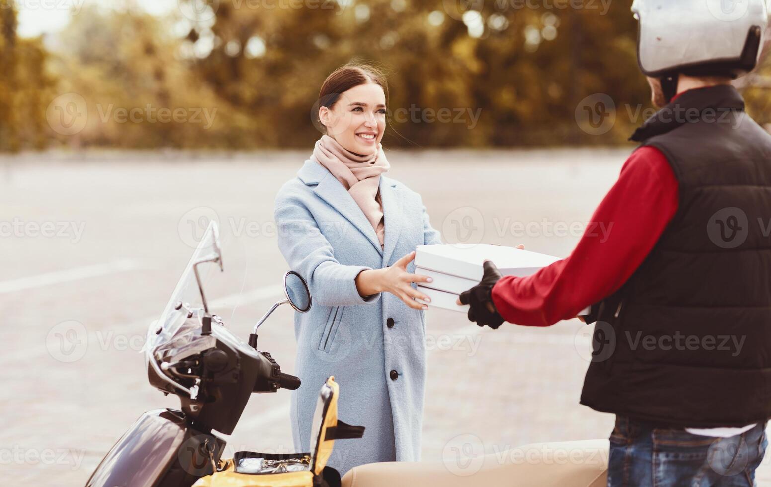 Pizza Delivery. Customer Girl Receiving Food Order From Pizzeria Standing With Courier Outdoors. Selective Focus photo