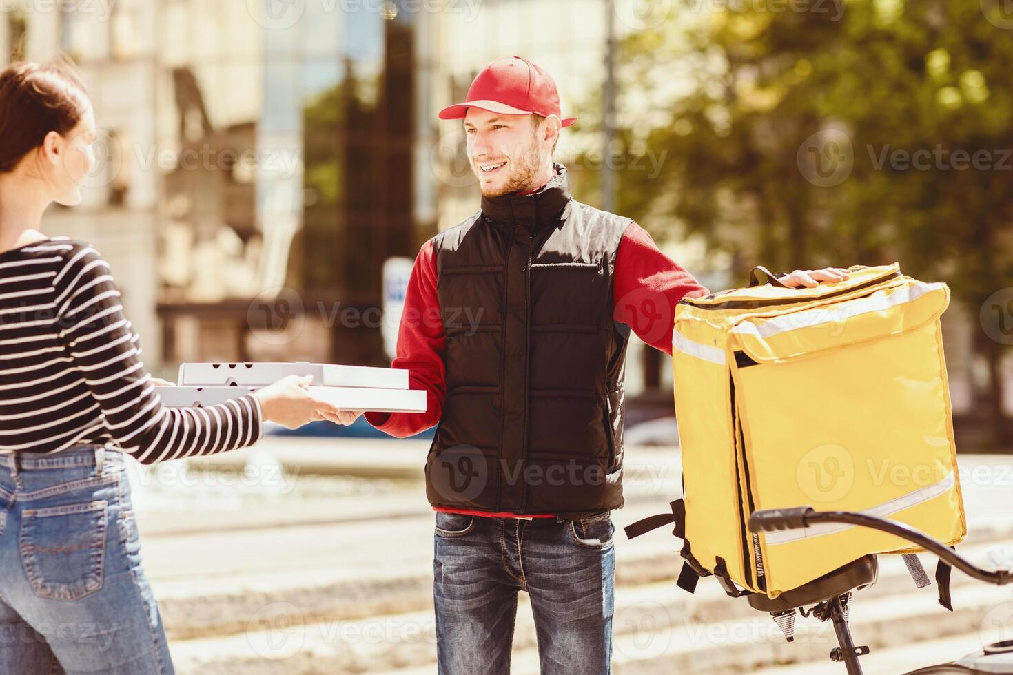 Pizza Delivery Concept. Courier Man Delivering Order From Pizzeria To Customer Giving Pizzas Boxes Standing Outdoors. Selective Focus photo