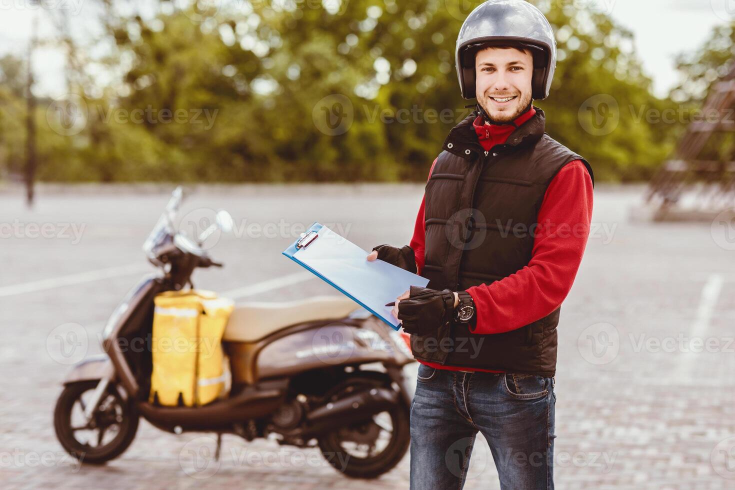 Courier Job. Delivery Guy Offering Delivering Services Holding Folder And Pen Standing Near Scooter Outdoors photo