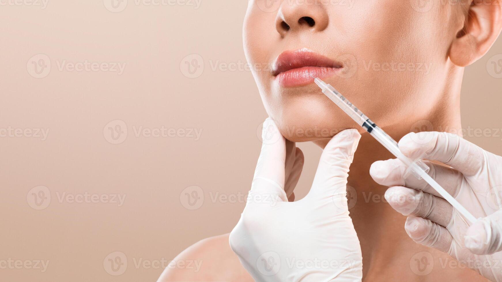 Lip injection for unrecognizable young woman, cropped, grey studio background, copy space photo