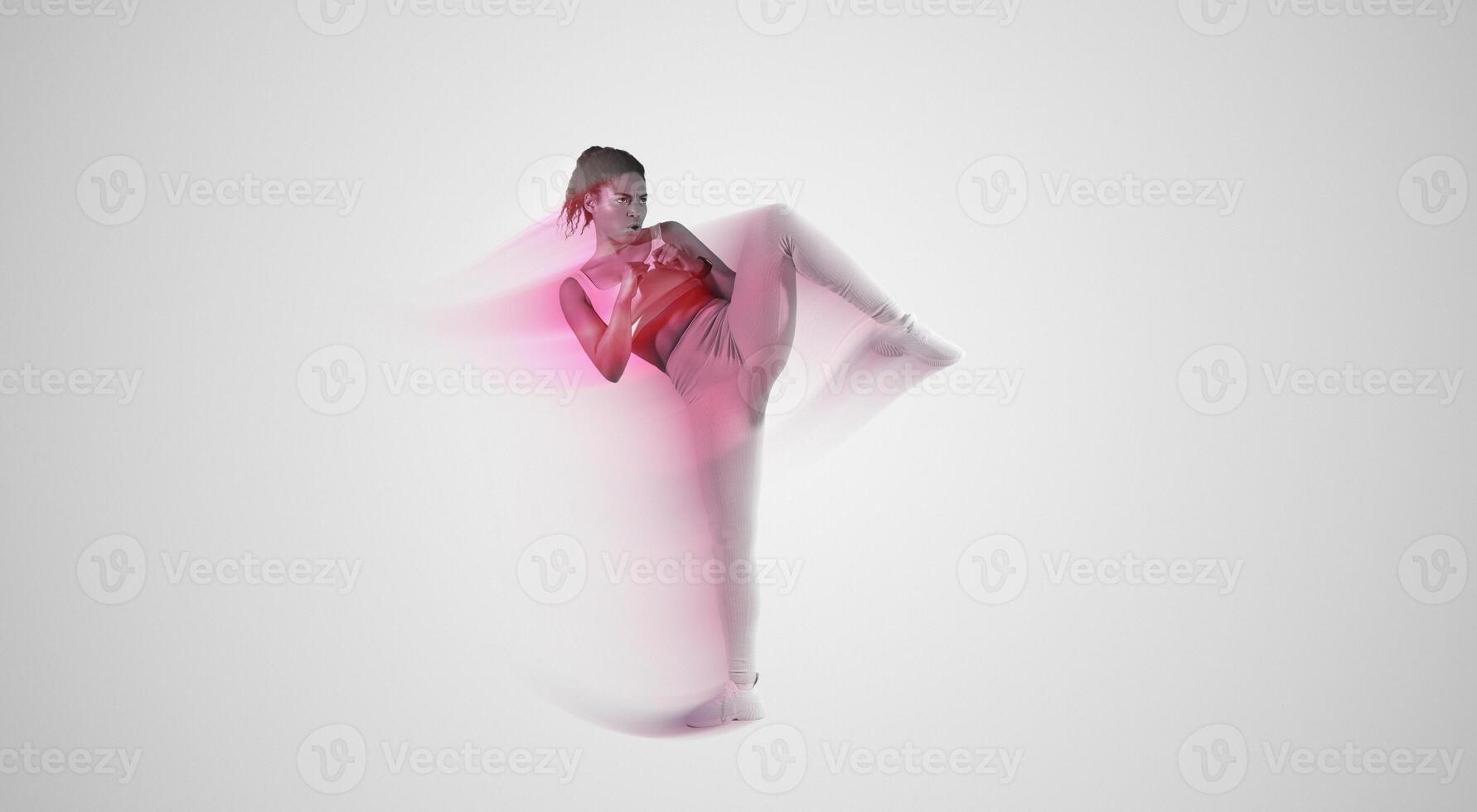 Lady trainer showing kick exercise for self defense by legs on studio background, copy space. African american woman training in sportswear in studio photo