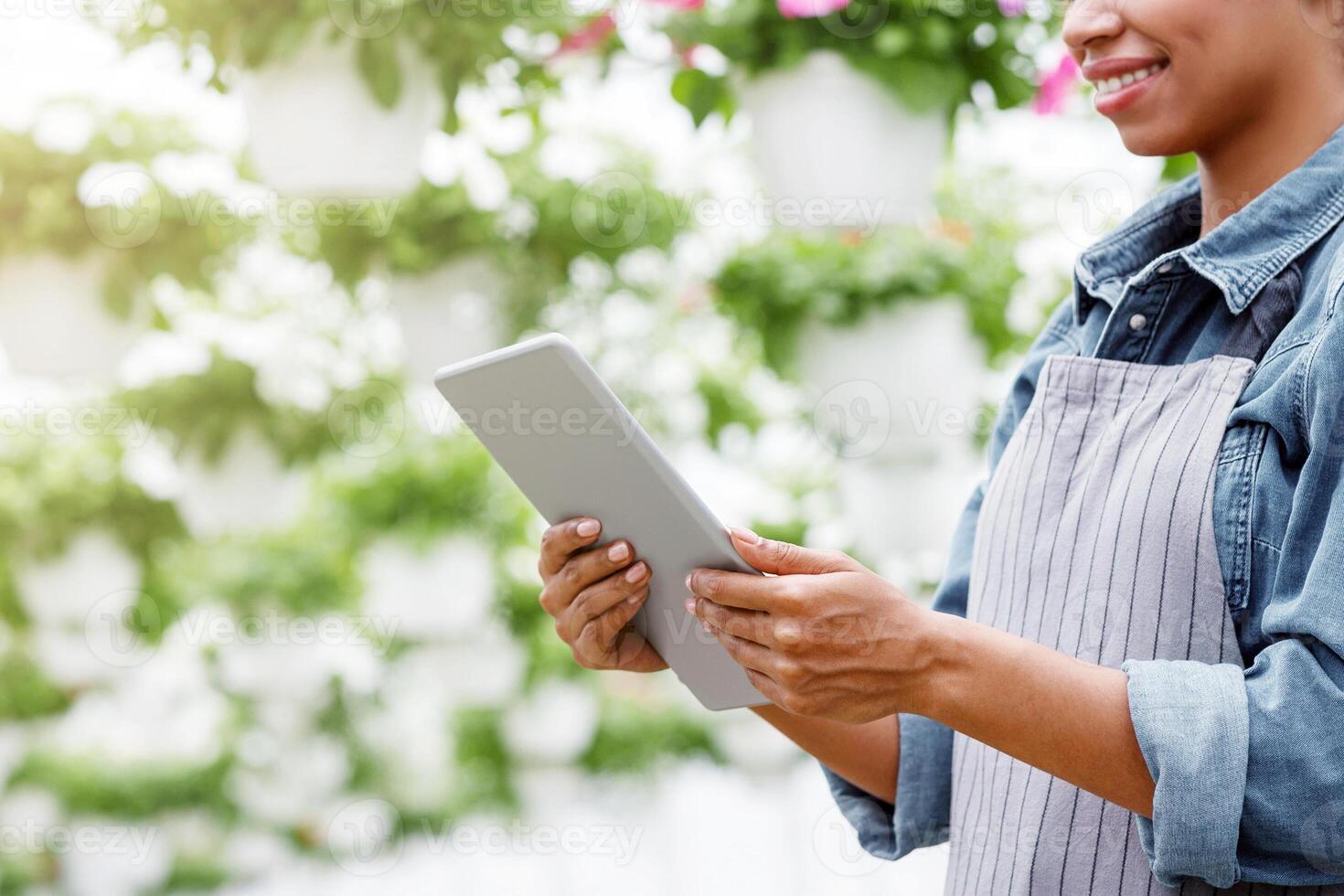 Work on farm and modern technology concept. Farmer checking quality greenhouse with digital tablet, panorama photo