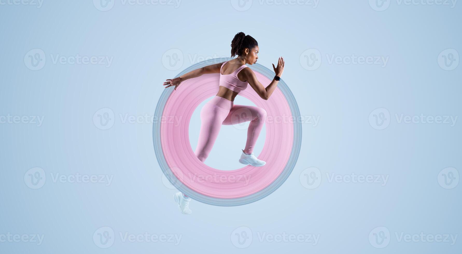 Sporty african american lady running in mid air over blue neon background, panorama with free space. Woman runner wearing fitwear during fitness workout. Sport and active life photo