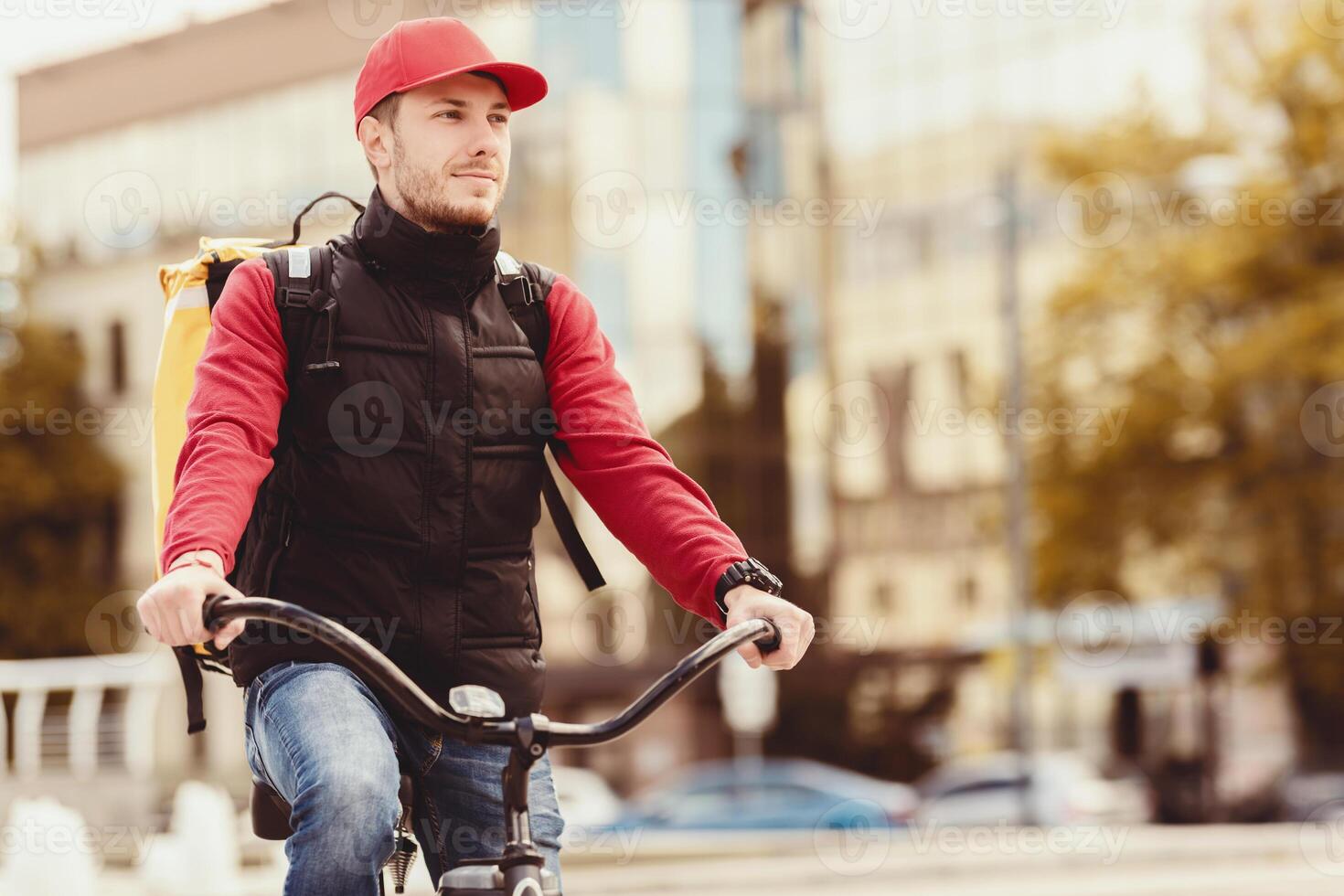 Delivery Guy With Delivering Backpack Posing With Bike In Urban Area Outdoors. Courier Service Concept. Blank Space For Text photo