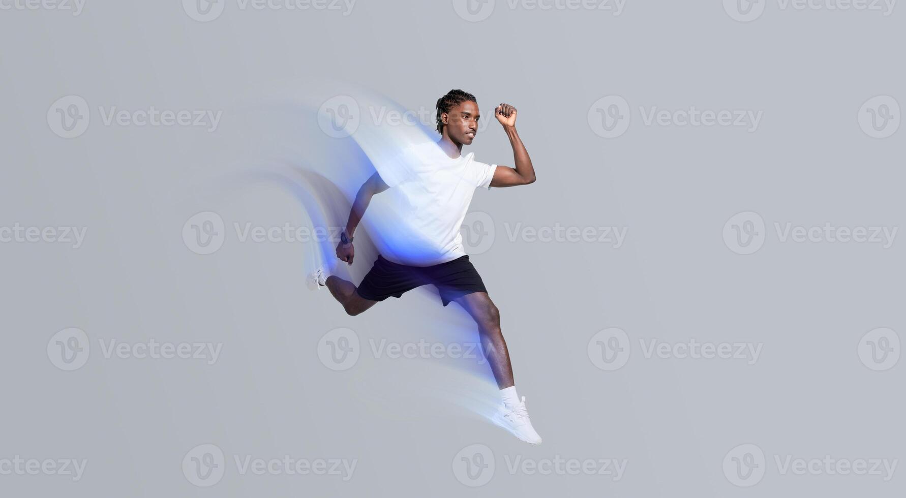 Dynamic man in sportswear running on grey studio background, in motion shot of motivated young african american guy showcasing fitness and active lifestyle, full length, copy space photo