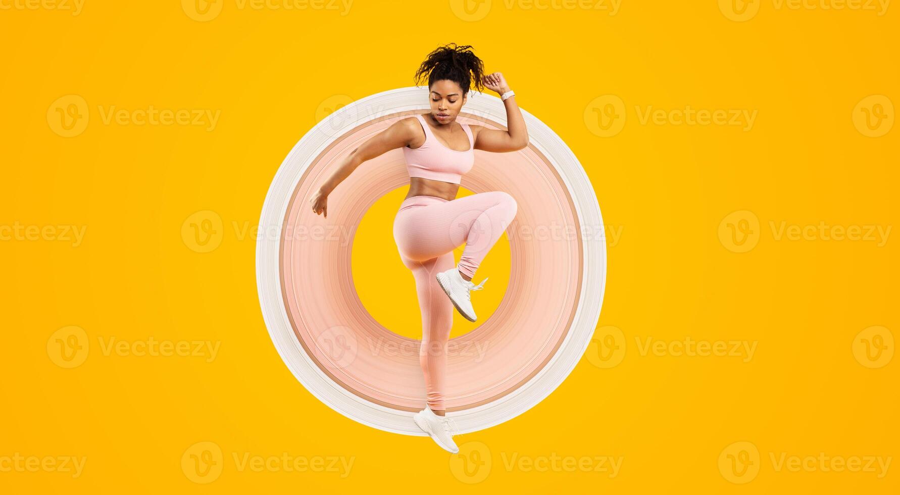 Vivid image of an african american lady in mid-air fitness routine, showcasing energy and liveliness, isolated against a yellow background photo