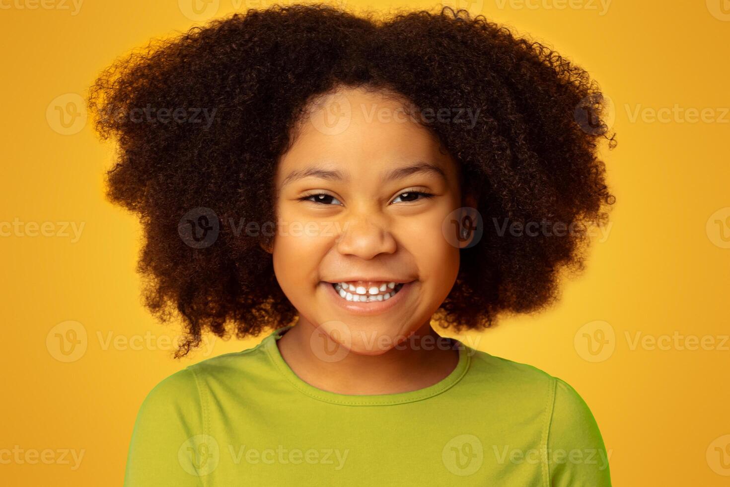 Closeup Portrait Of Funny Cute African American Little Girl Laughing At Camera, Posing Over Yellow Background In Studio, Free Space photo