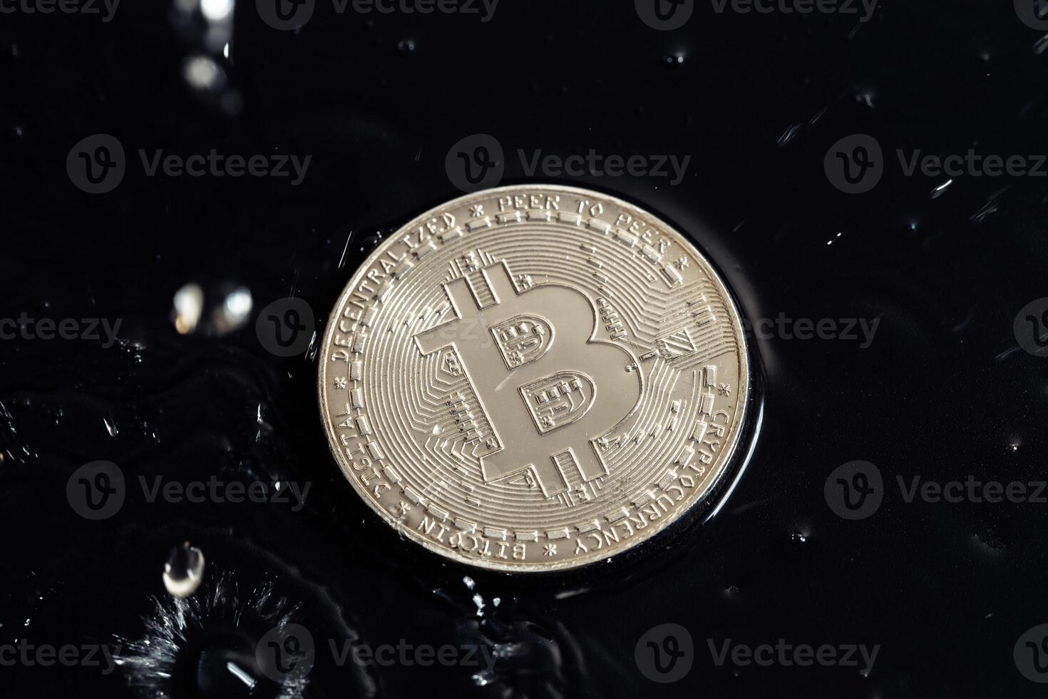 Cryptocurrency coins on a dark background. Rain drops on coins. photo