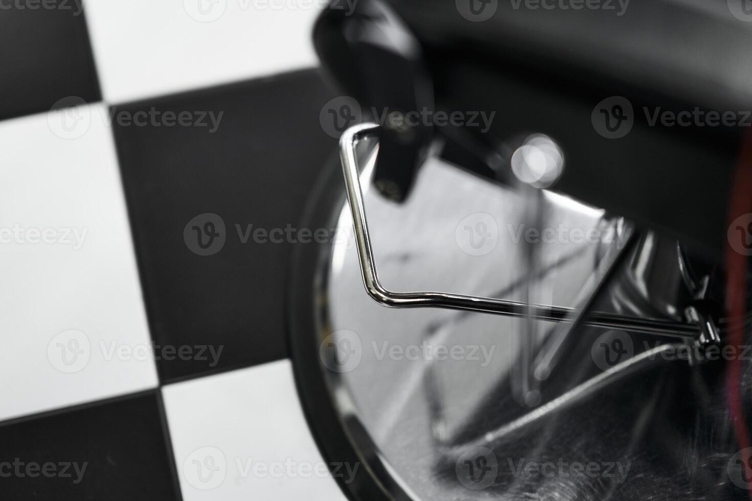 Black and white checkered floor with a barber chair detail in a stylish salon photo