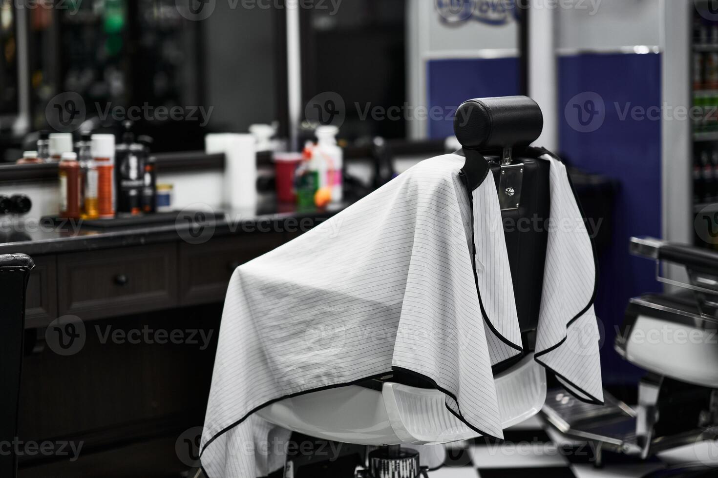 Barber chair in a well-equipped mens grooming salon during a busy afternoon photo