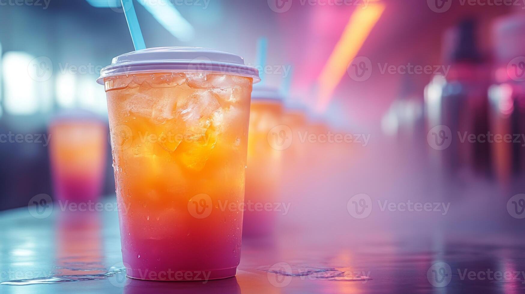 Refreshing drinks with layers of bright colors sit on a table in a dimly lit cafe, surrounded by a playful mist and illuminated neon lights. photo
