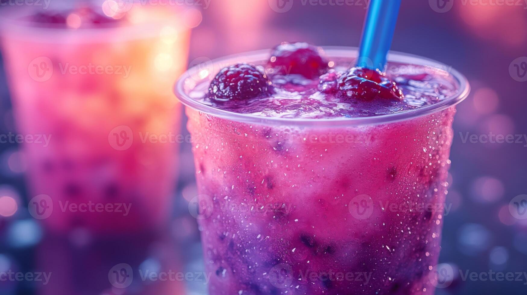 Colorful berry drinks filled with ice and topped with fresh berries are enjoyed at a lively summer gathering. The ambience is bright and festive during sunset. photo
