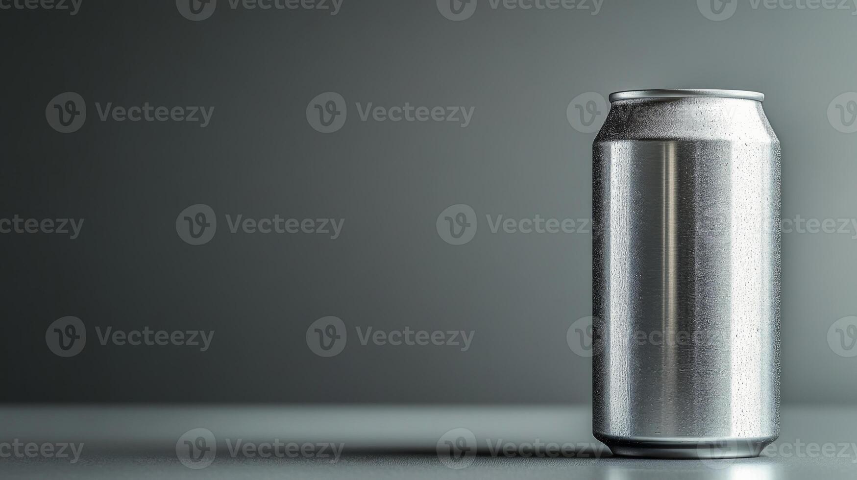 A shiny silver can stands upright on a smooth surface, illuminated by soft light against a plain dark backdrop, highlighting its sleek design and metallic finish. photo