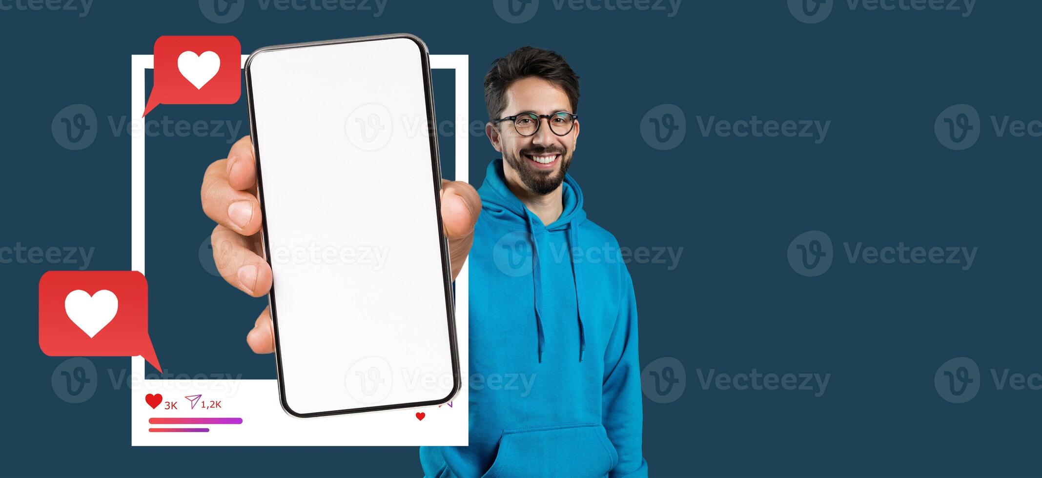 A smiling influencer holds a smartphone with a blank screen showcasing a social media application. The blue background enhances the focus on the phone and messaging elements. photo
