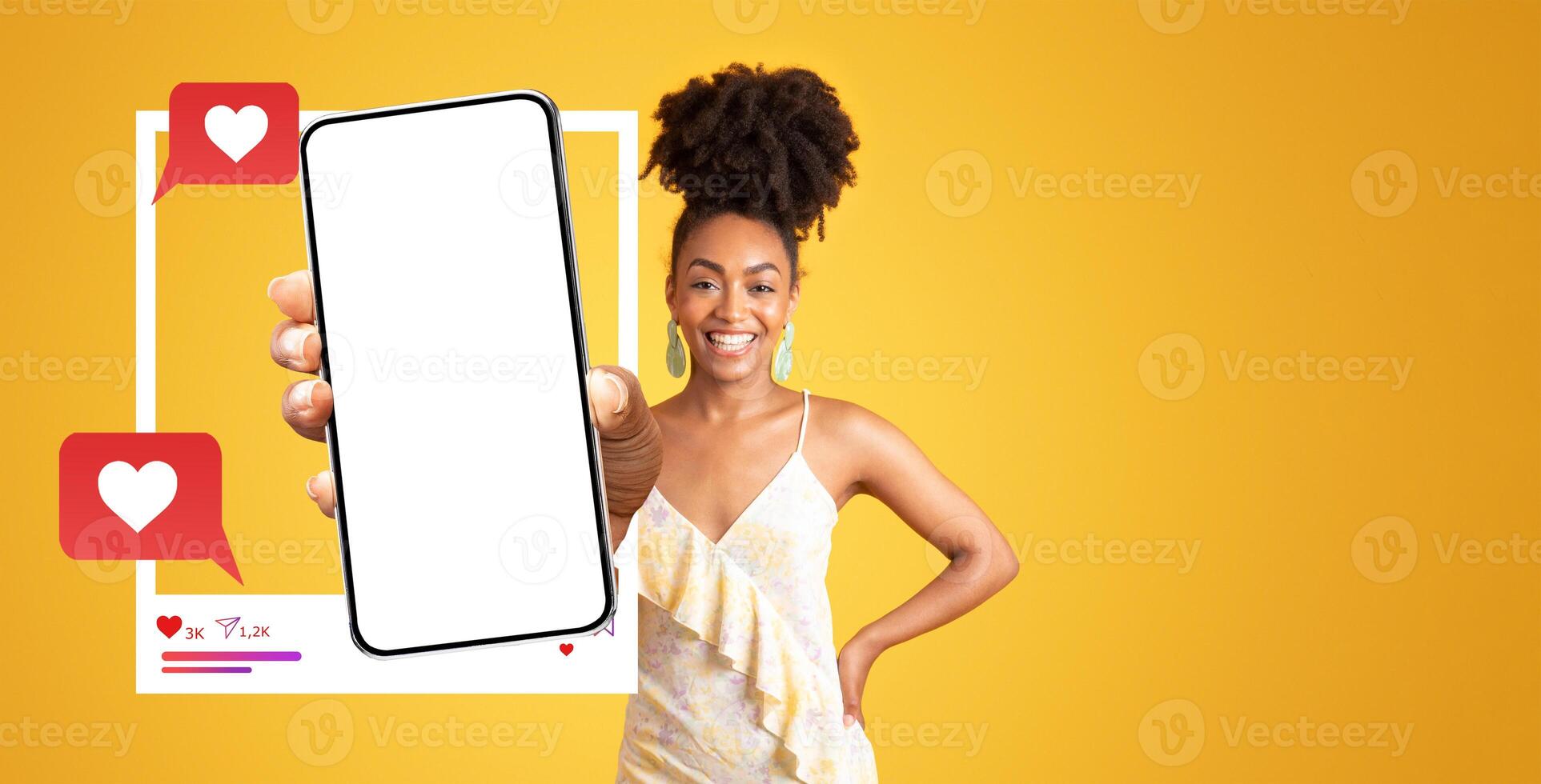 An energetic influencer proudly holds up a smartphone with a blank screen, symbolizing online engagement. The vibrant yellow background highlights the theme of social media interaction. photo