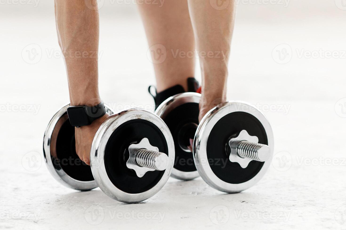 Health and strength training. Woman with fitness tracker doing hand bends and exercises with dumbbells at home during quarantine, cropped, copy space photo