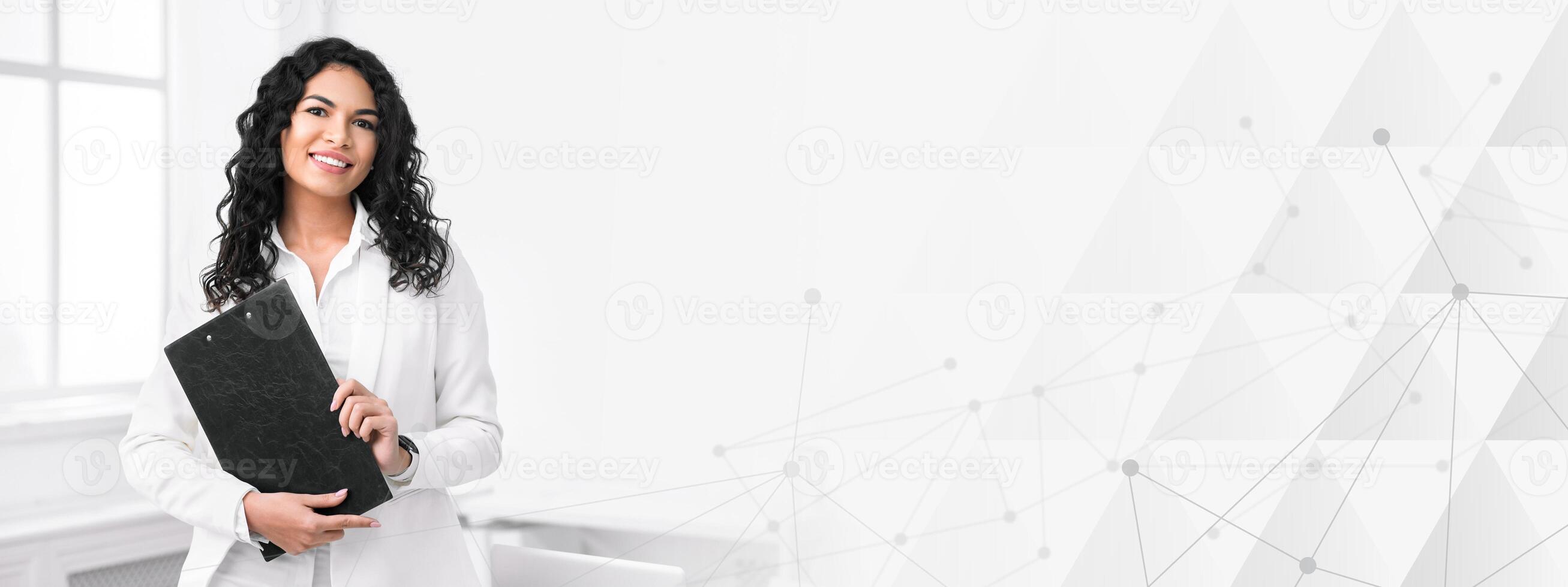 Successful Businesswoman. Portrait of smiling hispanic manager standing with clipboard, looking at camera, free space photo