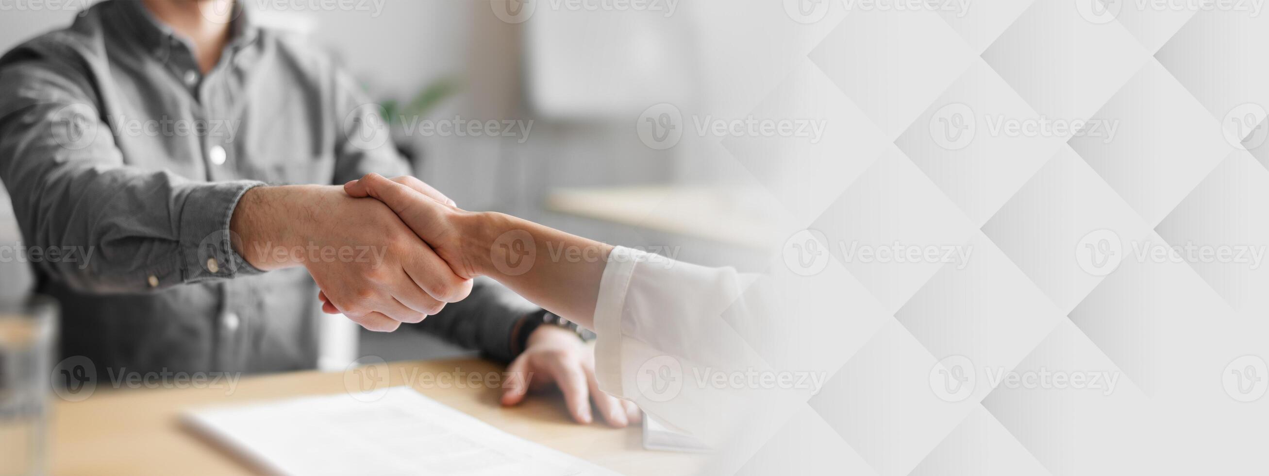 Cropped view of human resources manager shaking hands with successful vacancy applicant at office, closeup. Unrecognizable headhunting specialist welcoming new employee into company team photo