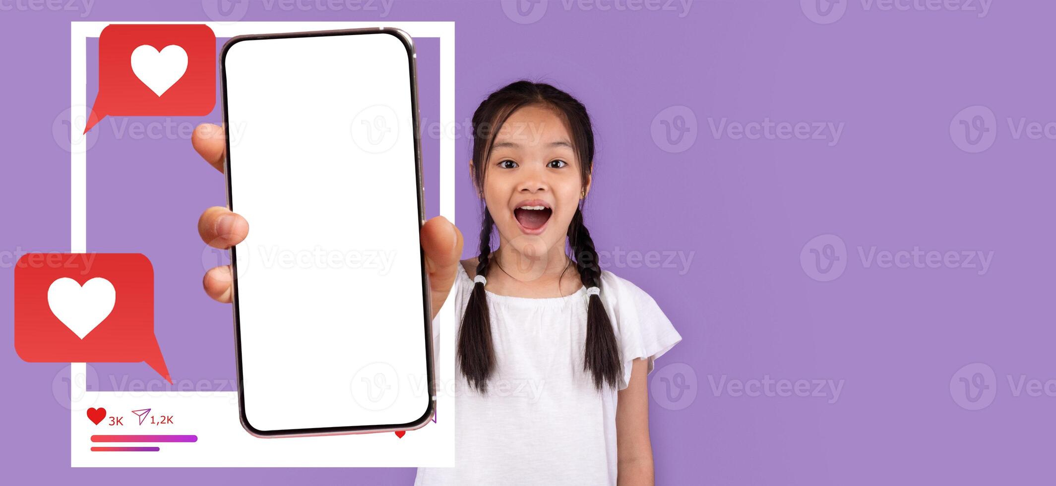 Asian girl young influencer excitedly holds a smartphone with a blank screen, showcasing a lively expression. Colorful chat bubbles and hearts surround her, emphasizing social media engagement. photo