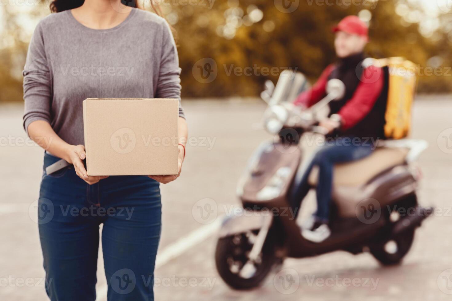 Delivery Service. Unrecognizable Customer Girl Holding Boxes Standing Near Courier Guy Outside. Cropped, Selective Focus photo