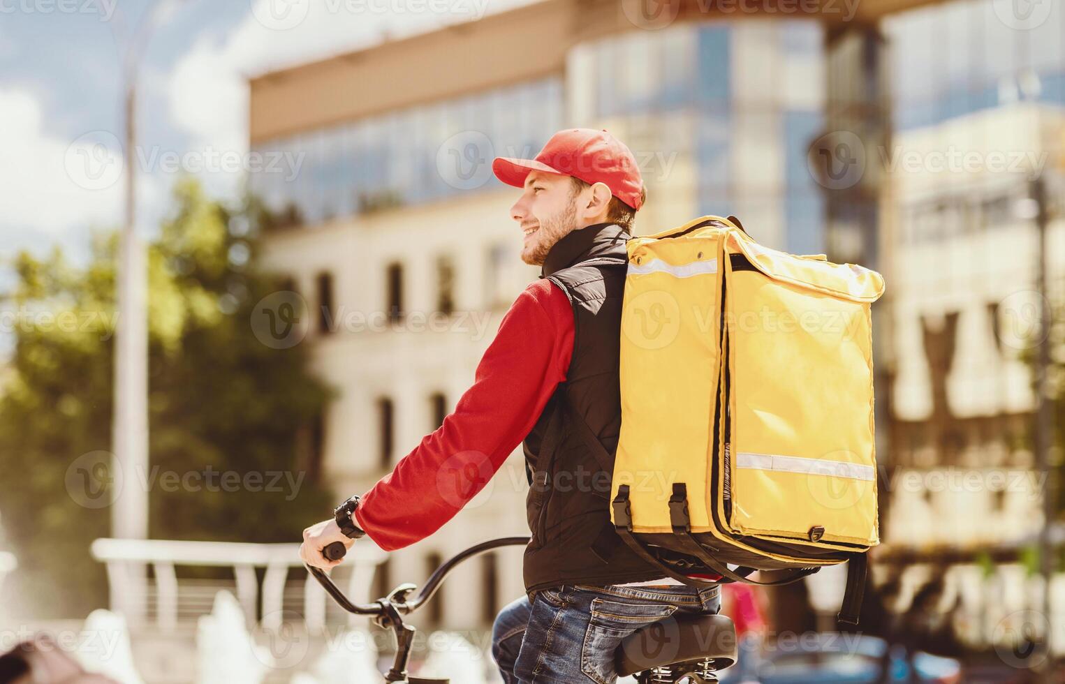 Courier Guy Delivering Food Riding Bike In City, Working In Meal Delivery Company. Free Space For Text photo