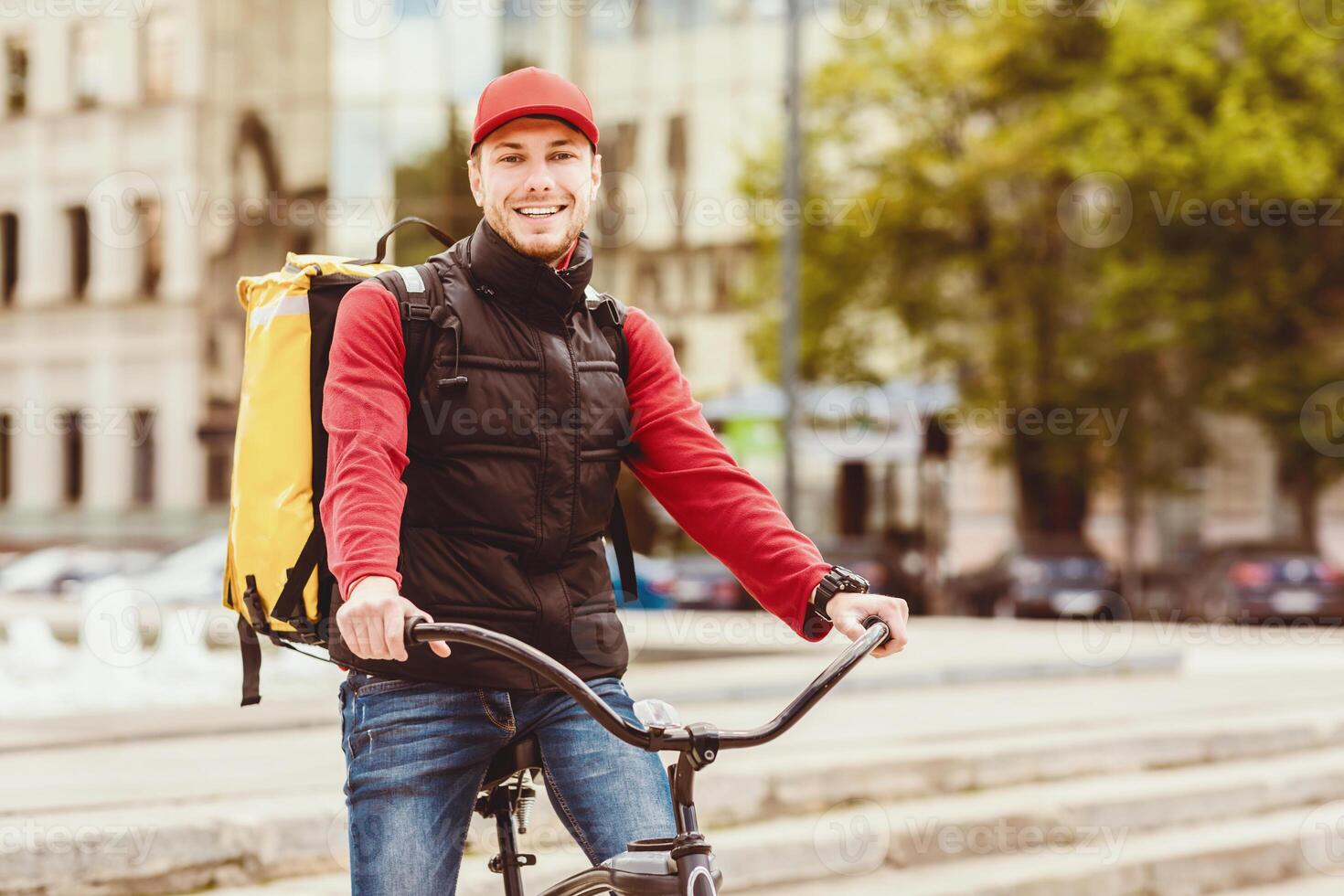 Courier Service. Delivery Guy On Bicycle Smiling To Camera Posing With Bike In City Outdoors. Empty Space For Text photo